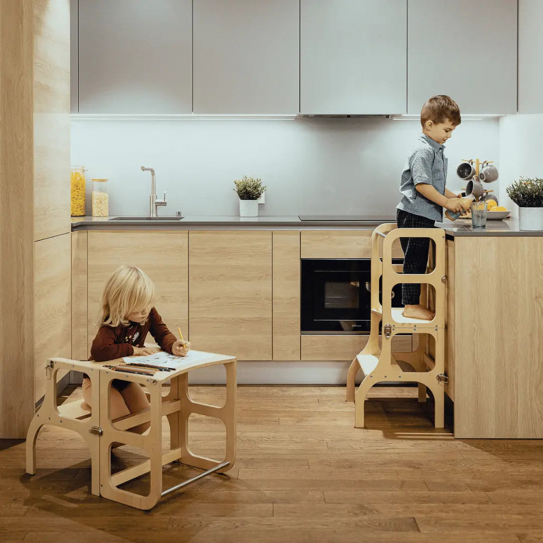Child using STEP’n’SIT helper tower at kitchen counter