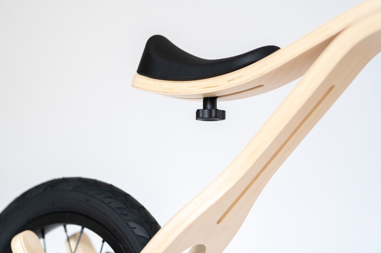 Child riding adjustable wooden balance bike outside — Balance Bike 3in1 — AlmaVidaKids